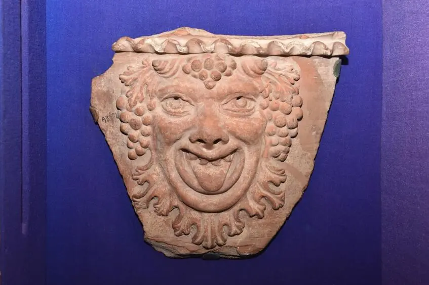 A fragment of a pythos with a Silenus mask