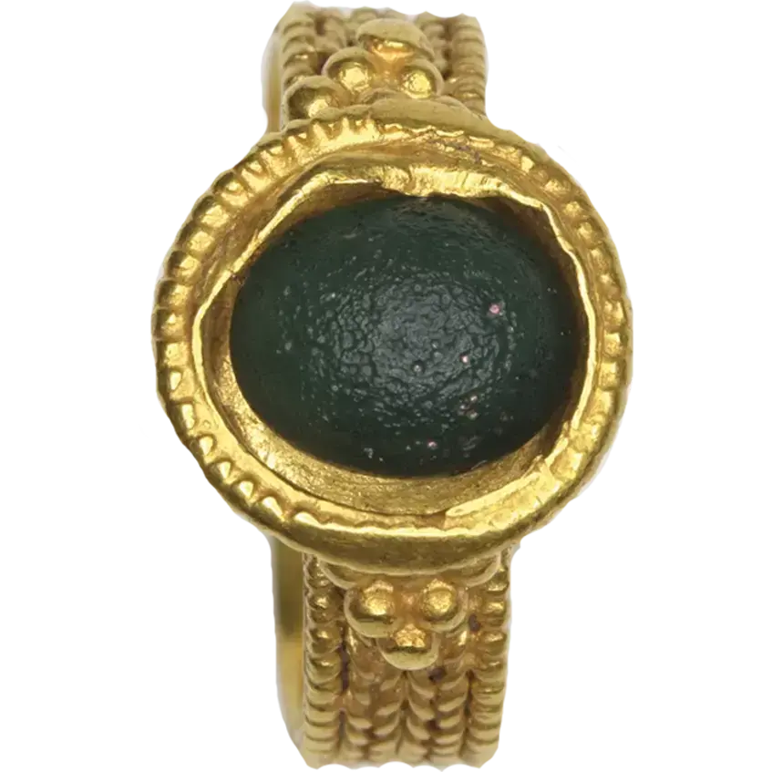 Ring with a round shield decorated with grainy ornaments
